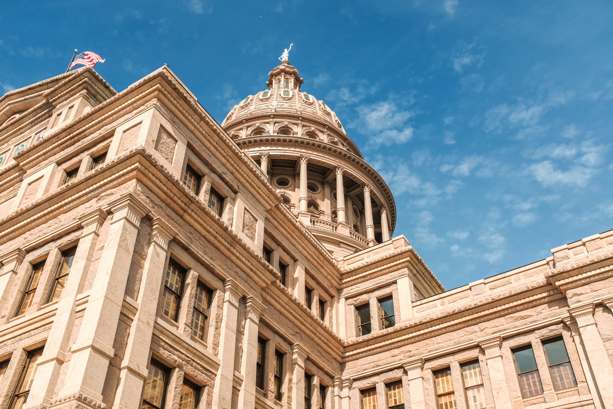 Texas State Capitol dome and facade against a blue sky in Austin