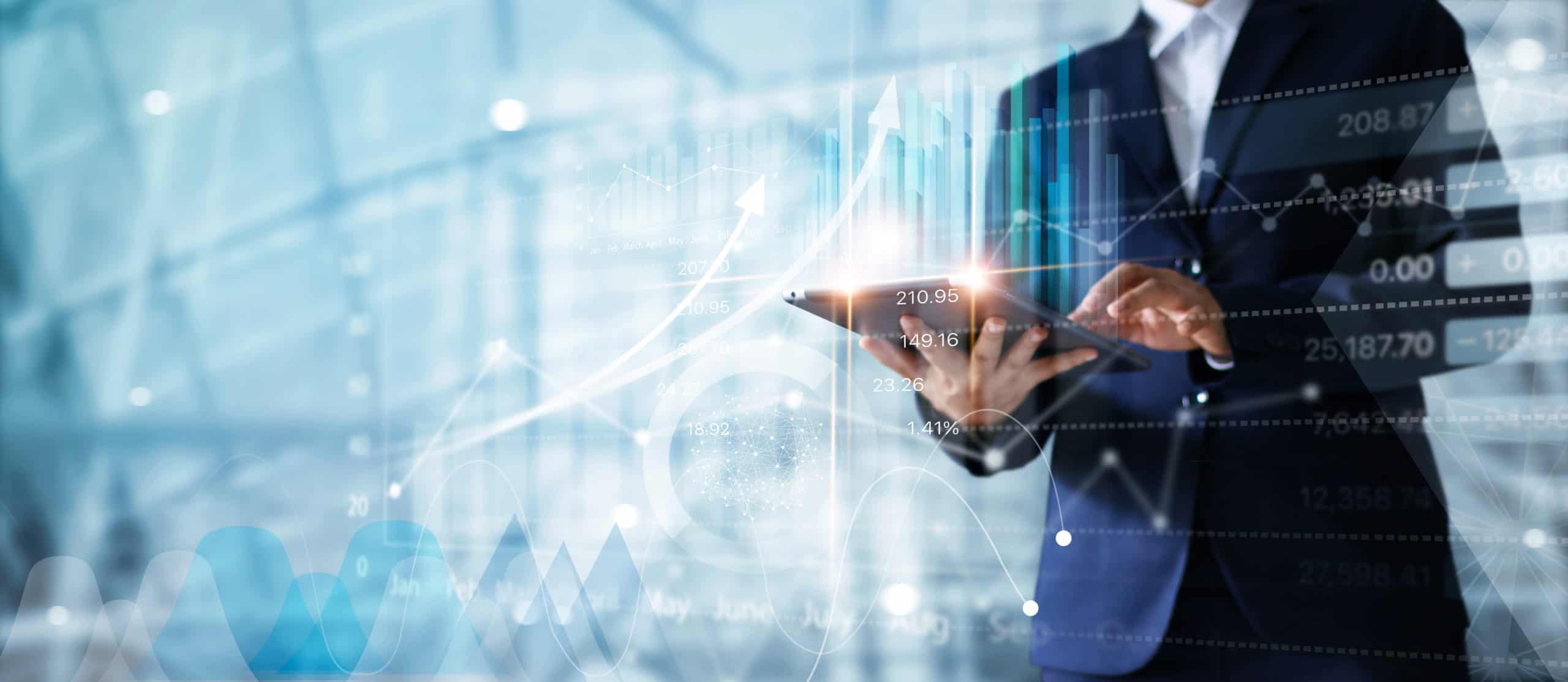 Businessman holding a tablet with glowing growth charts and financial data overlaid