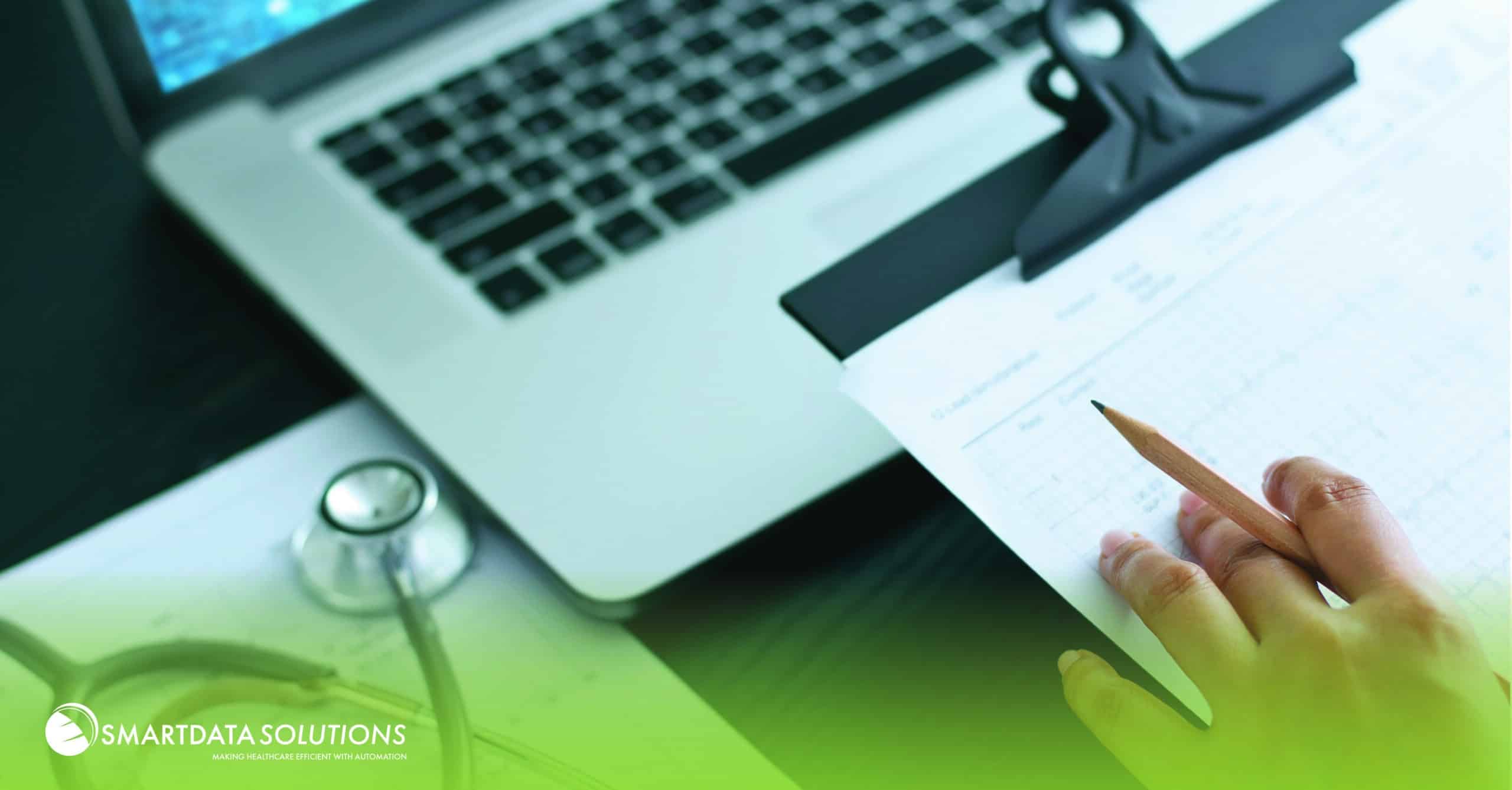 Laptop, stethoscope and clipboard on a desk