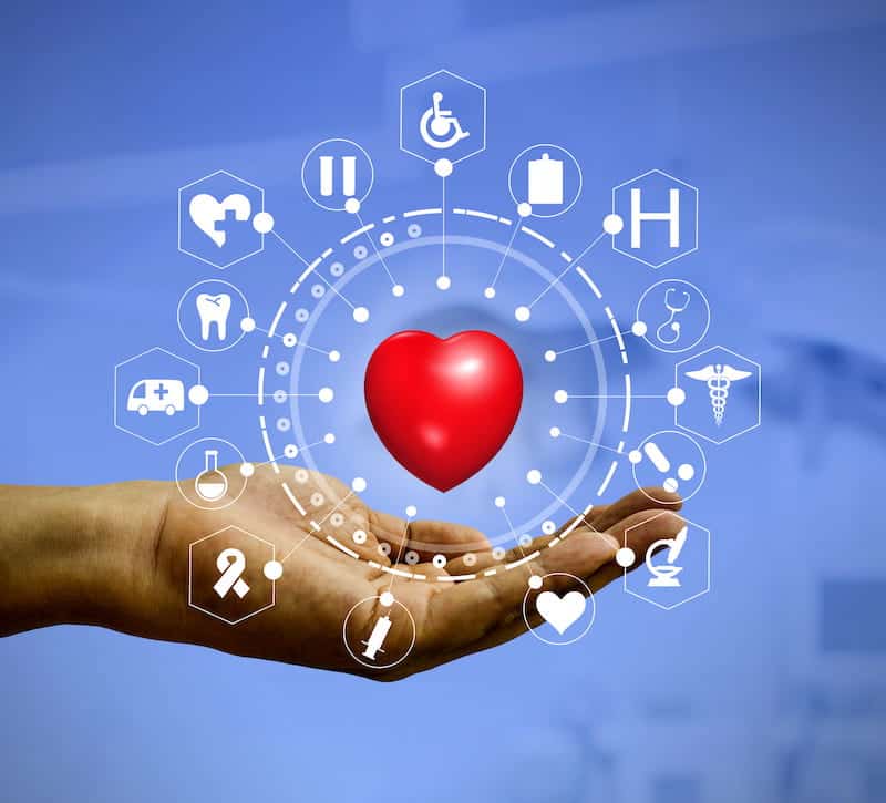 Red heart above an open hand surrounded by connected healthcare icons
