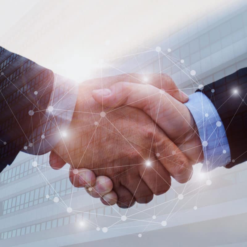 Handshake overlaid with a network of connected lines