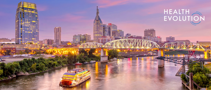 Health Evolution logo over a city skyline and river at dusk