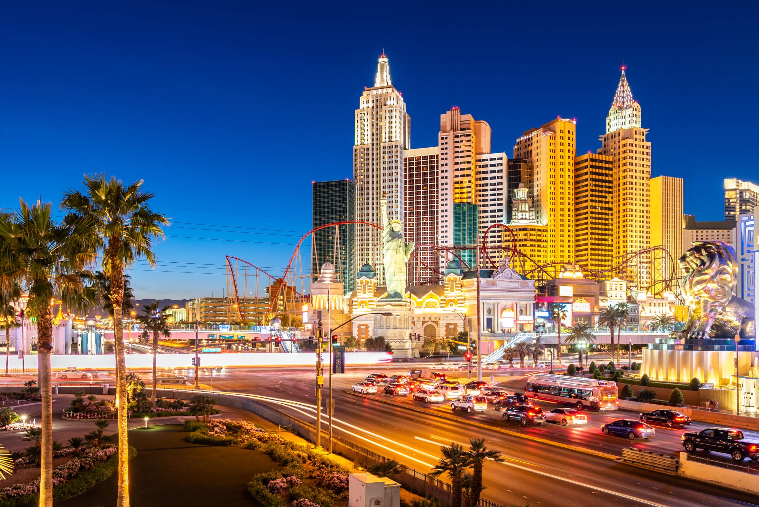 Las Vegas Strip at dusk with lit hotel towers and traffic