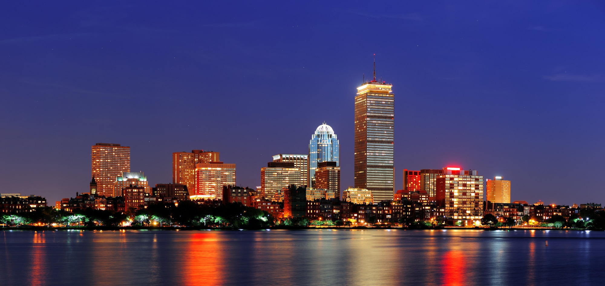 City skyline at night reflected in the water