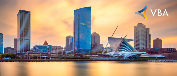 VBA logo over a city skyline at sunset