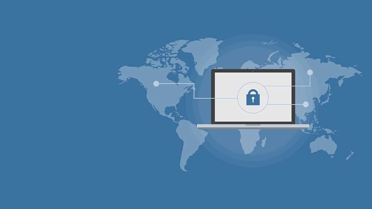Laptop with a padlock on a world map, representing global vendor security and compliance